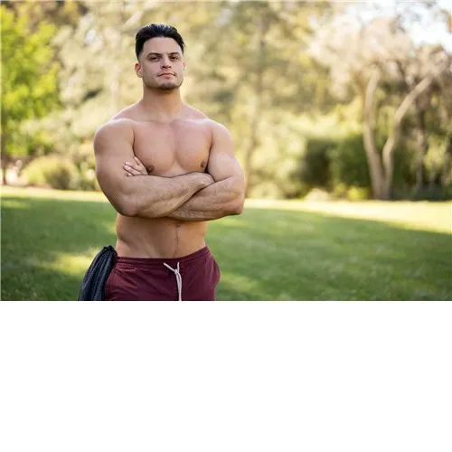 Male posed topless outdoors displaying chest